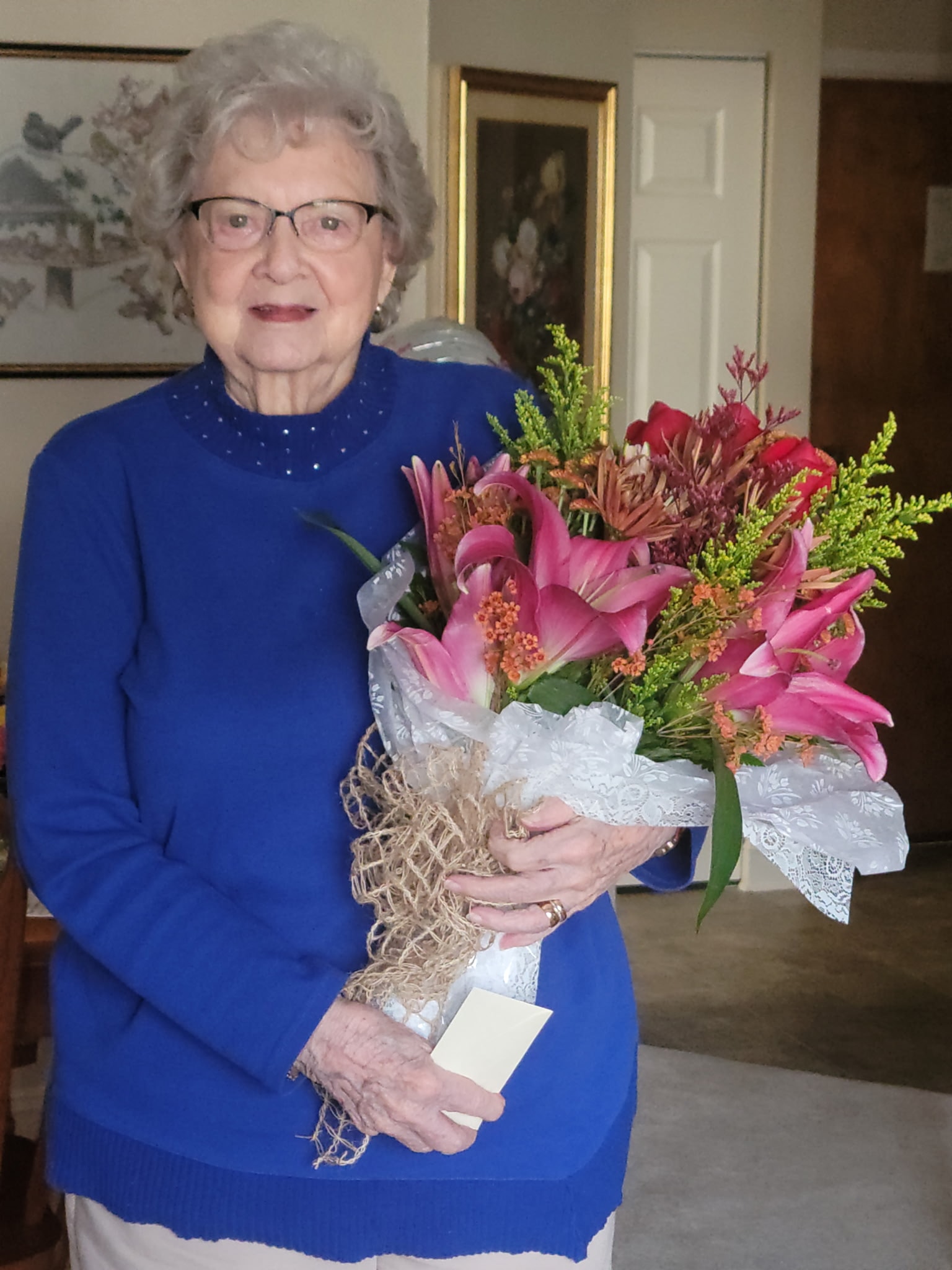 Client holding a beautiful pink flower bouquet — Peaceful Place Home Care, Matthews NC